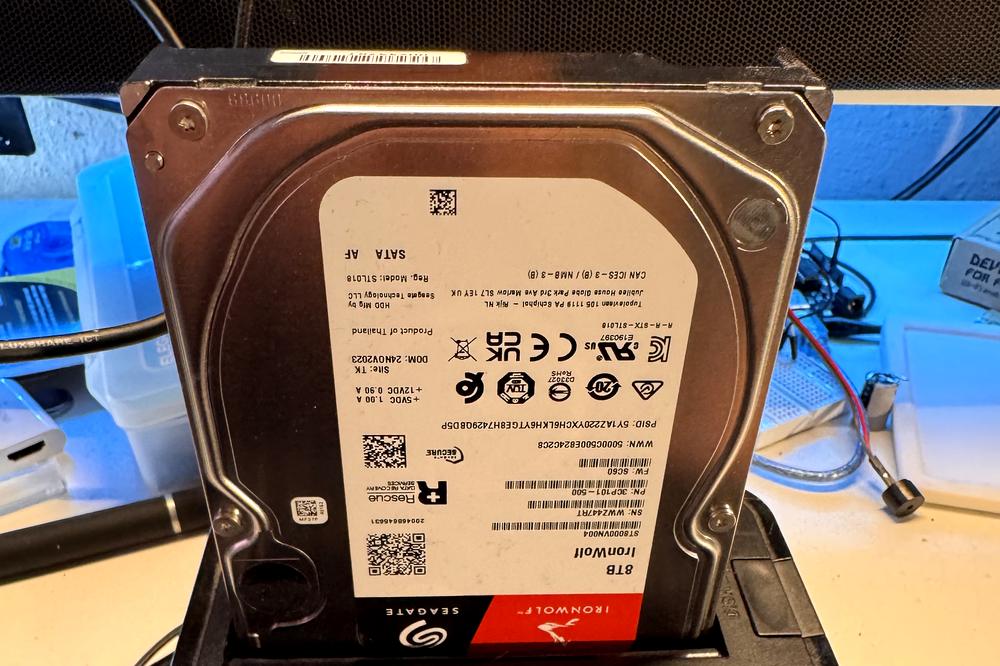 A Seagate IronWolf 8TB hard drive seated in a dual-bay docking station for data recovery and backup.